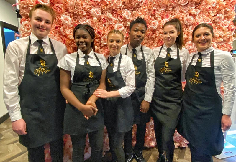 Little Dessert Shop team in embroidered black aprons, white shirts and bespoke ties