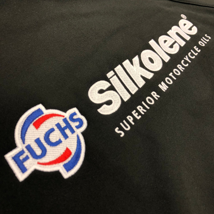 FUCHS and Silkolene logos embroidered together on a black work jacket, showing multi-brand embroidery for Fuchs Lubricants UK