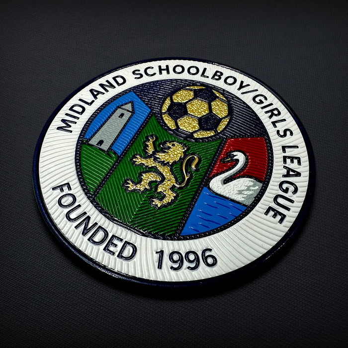Moulded TPU league badge with fine raised lettering, textured colour fills and a crisp outer edge